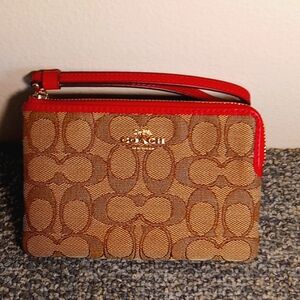 Coach brown and tan canvas zip around red leather lined women's wristlet